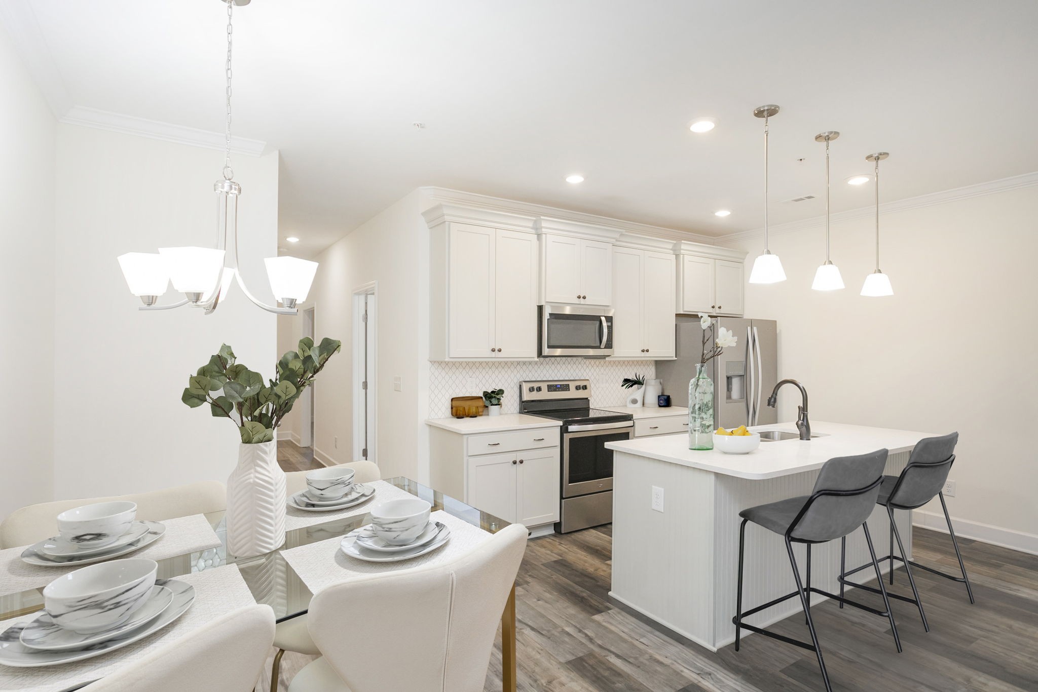 145 Mary Ann Circle Spring Hill, TN 37174 - Photo 11 of 36 a kitchen with stainless steel appliances kitchen island granite countertop a sink a stove a dining table and chairs