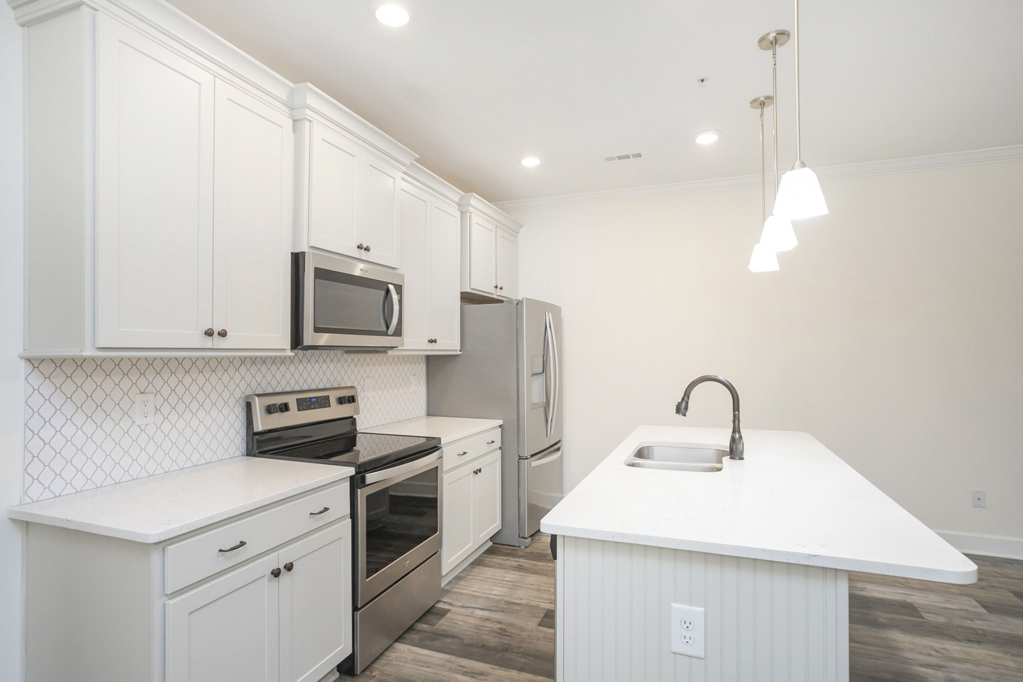 145 Mary Ann Circle Spring Hill, TN 37174 - Photo 15 of 36 a kitchen with a sink a microwave a stove and refrigerator