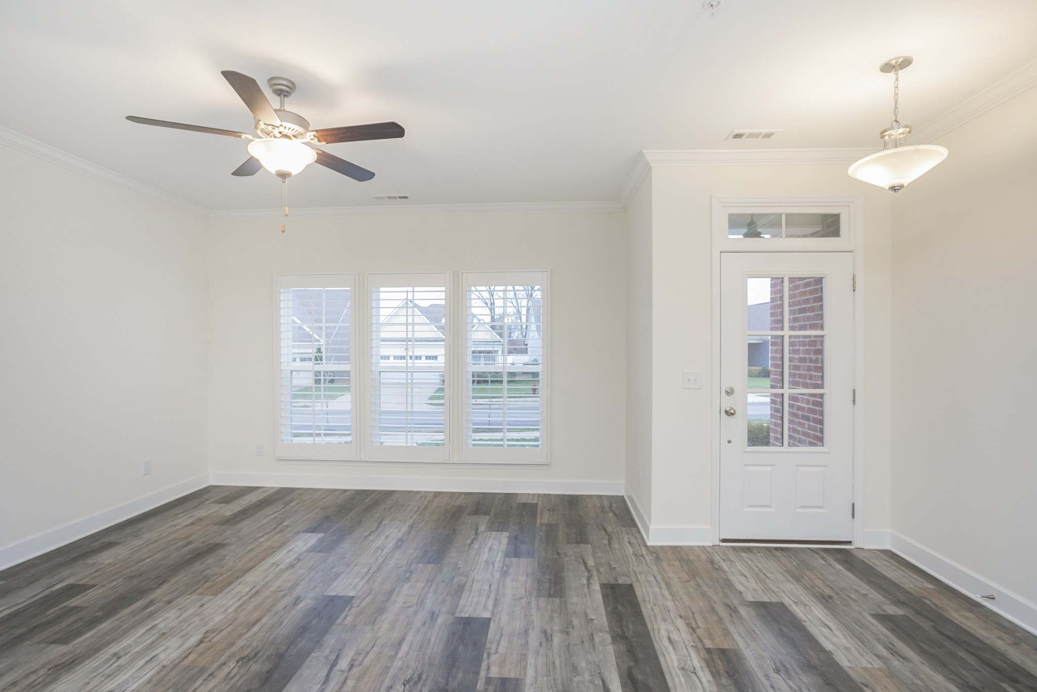 145 Mary Ann Circle Spring Hill, TN 37174 - Photo 9 of 36 a view of an empty room with wooden floor and a window