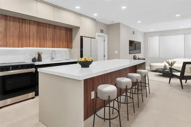 a kitchen with a dining table chairs and a refrigerator