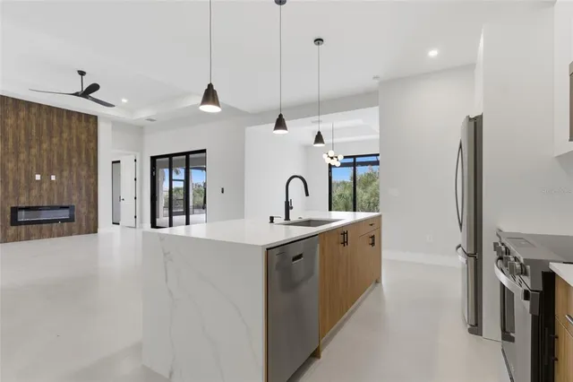 an empty room with a window and a ceiling fan