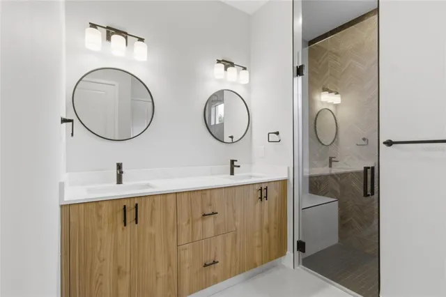 a bathroom with a shower and mirror