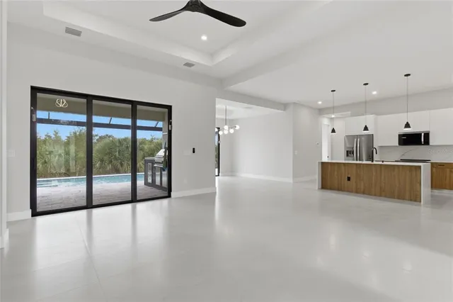 a view of a kitchen with a sink and a large window