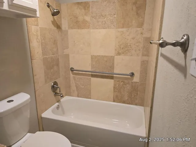 a bathroom with a bathtub and a toilet