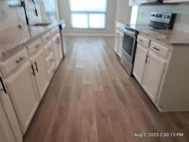 a view of a kitchen from the hallway