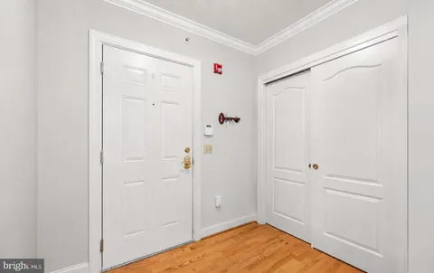 a view of a bedroom with wooden floor