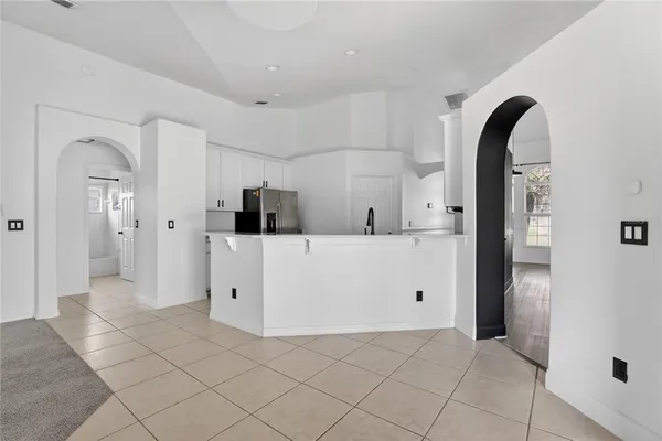 a view of a livingroom with wooden floor and a ceiling fan
