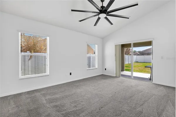 a en suite bathroom with a granite countertop sink a mirror and a bathtub