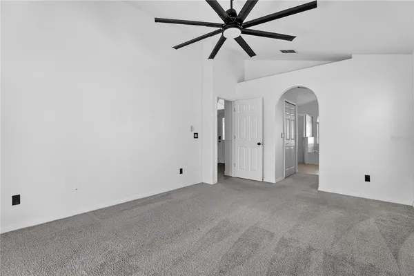 a bathroom with a tub a sink and a large mirror