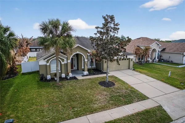 an aerial view of a house with a yard