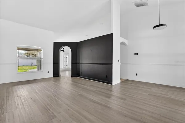 a view of a room with wooden floor