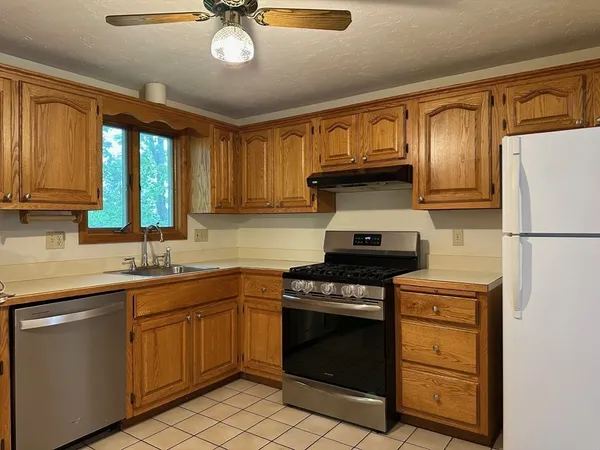 a kitchen with stainless steel appliances granite countertop a stove sink and cabinets