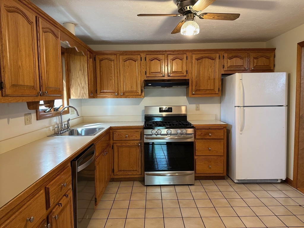 15 Curlew Street Boston, MA 02132 - Photo 14 of 30 a kitchen with stainless steel appliances granite countertop a stove a refrigerator and a sink