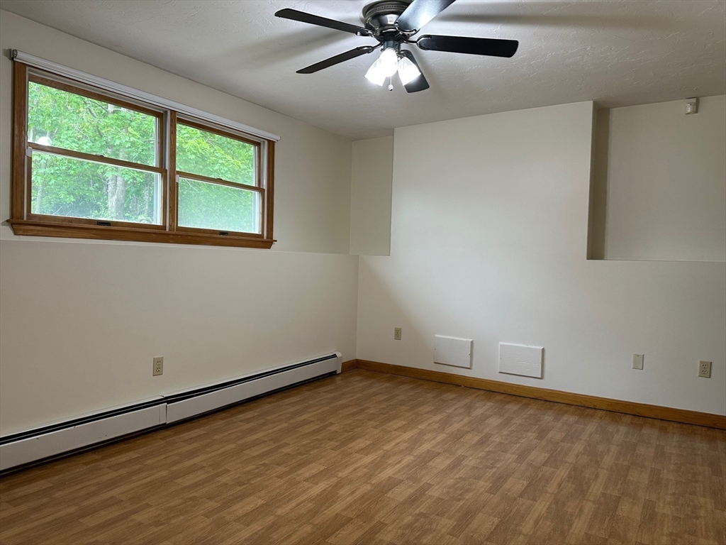 15 Curlew Street Boston, MA 02132 - Photo 18 of 30 a view of an empty room with wooden floor and a window