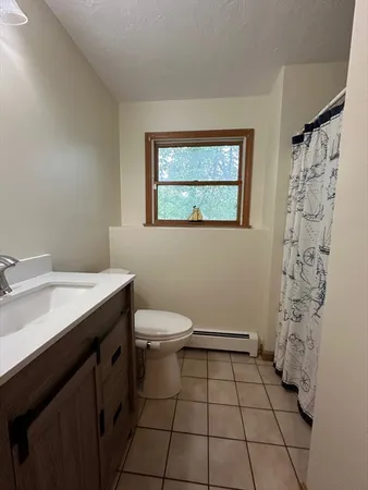 a bathroom with a toilet a sink and shower