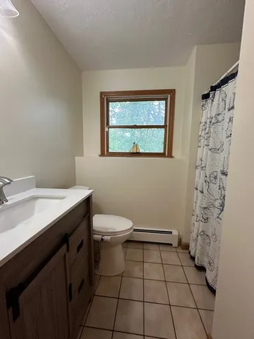 a bathroom with a toilet a sink and shower