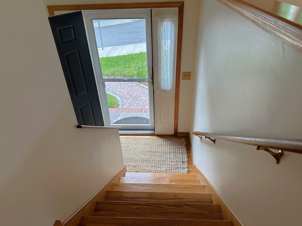 15 Curlew Street Boston, MA 02132 - Photo 2 of 30 a view of a hallway with wooden floor and staircase
