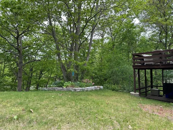 a view of outdoor space with deck and yard