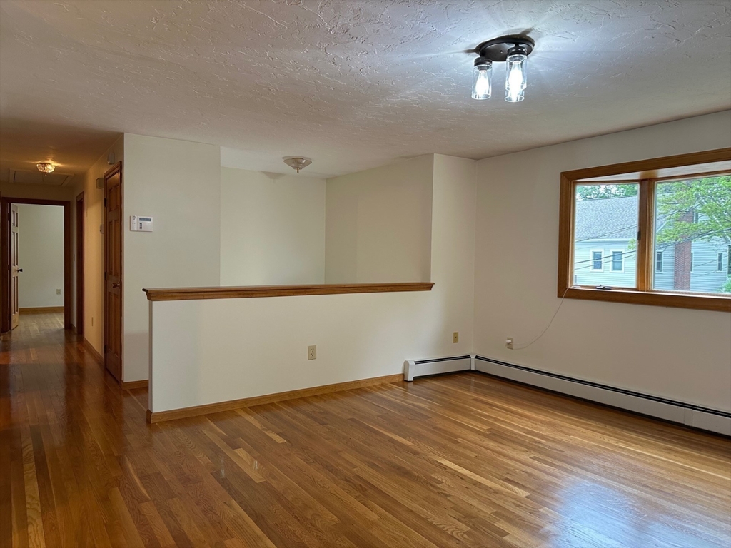15 Curlew Street Boston, MA 02132 - Photo 3 of 30 a view of a room with wooden floor and a window