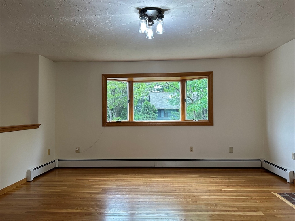 15 Curlew Street Boston, MA 02132 - Photo 4 of 30 a view of a room with a window and wooden floor
