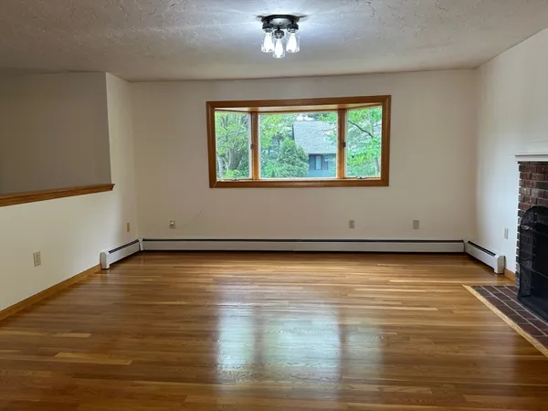 a view of a room with wooden floor and window