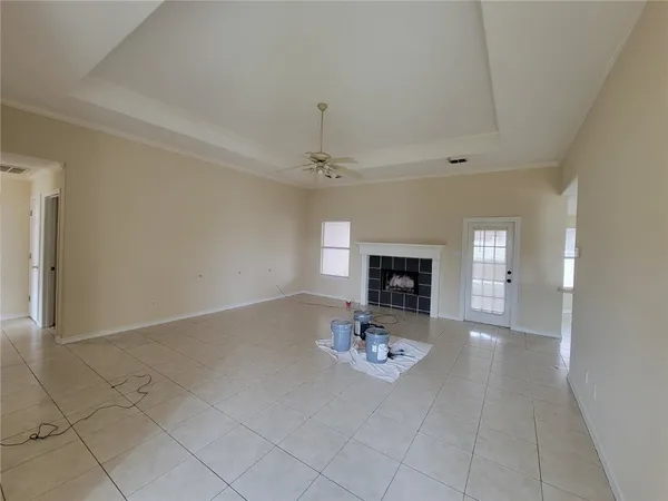 an empty room with fireplace and mirror