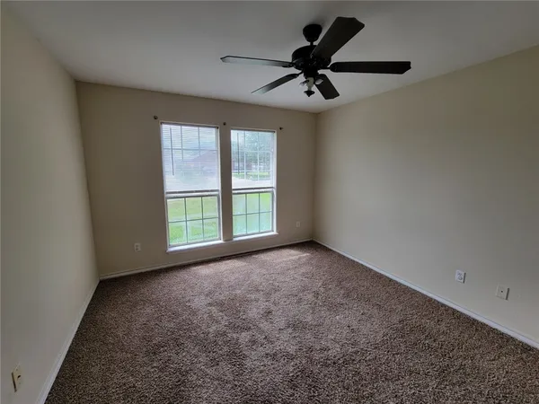 an empty room with windows and closet