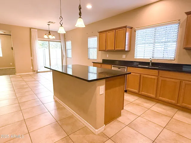 a kitchen with stainless steel appliances granite countertop a stove a sink and a granite counter tops