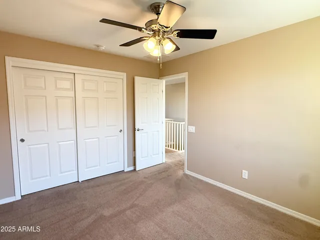 a view of a livingroom with a chandelier fan