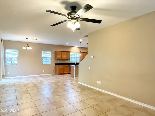 a view of a livingroom with a ceiling fan and window