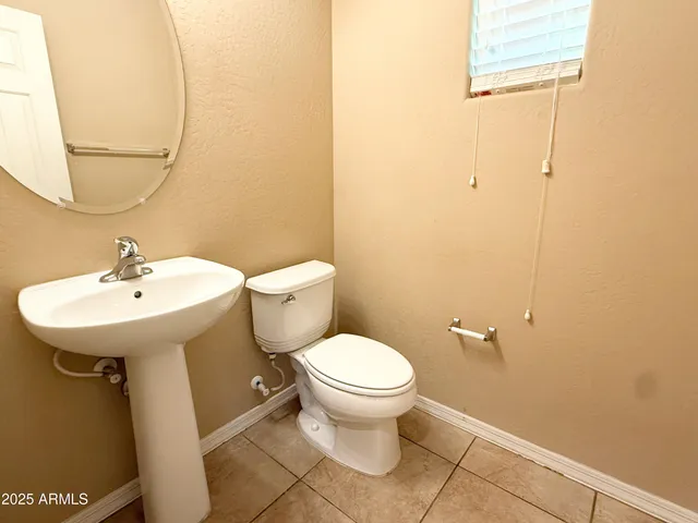 a bathroom with a sink toilet and a mirror