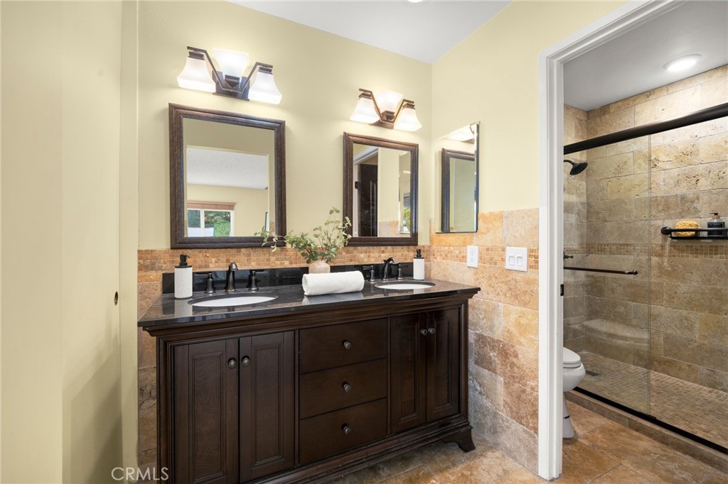 26017 Redbluff Drive Calabasas, CA 91302 - Photo 16 of 29 a bathroom with a double vanity sink and a mirror