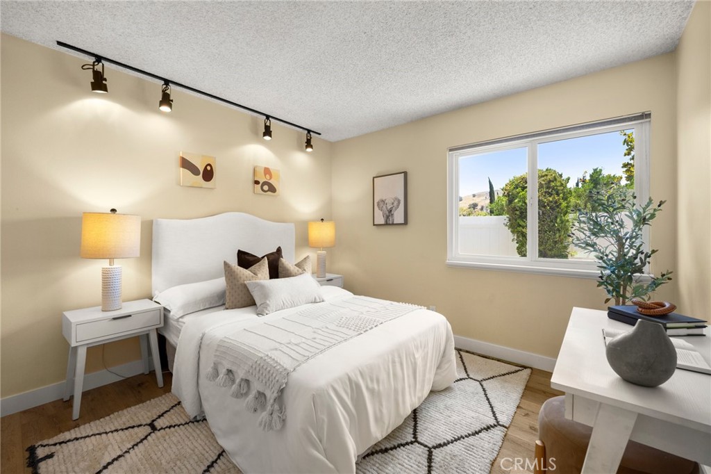 26017 Redbluff Drive Calabasas, CA 91302 - Photo 19 of 29 a bedroom with a bed and a chair