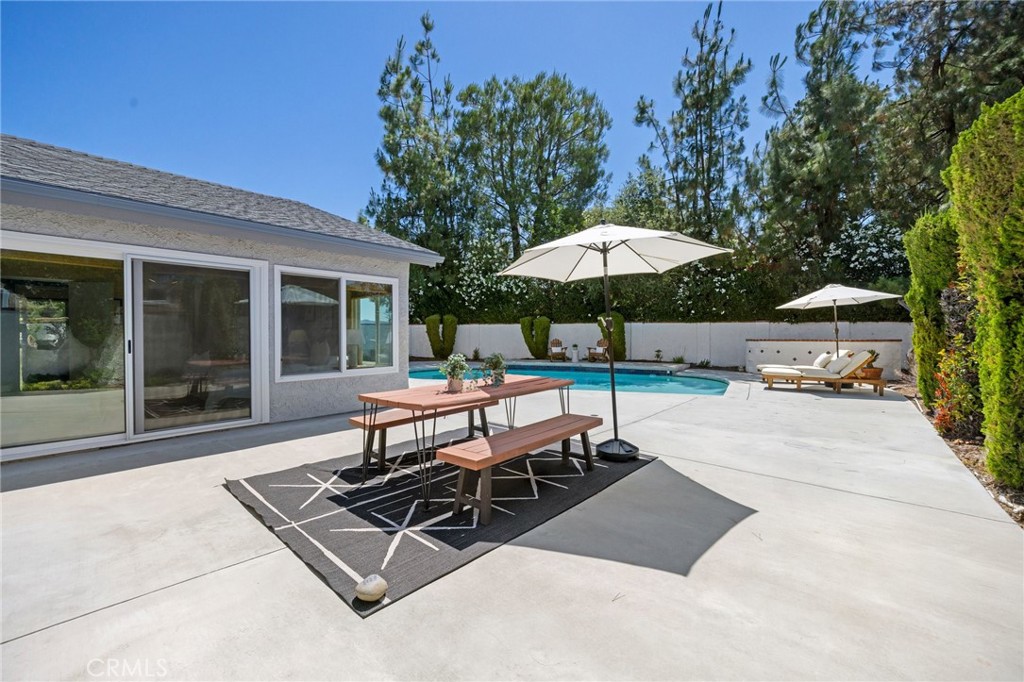 26017 Redbluff Drive Calabasas, CA 91302 - Photo 22 of 29 a view of a backyard with a patio and outdoor seating