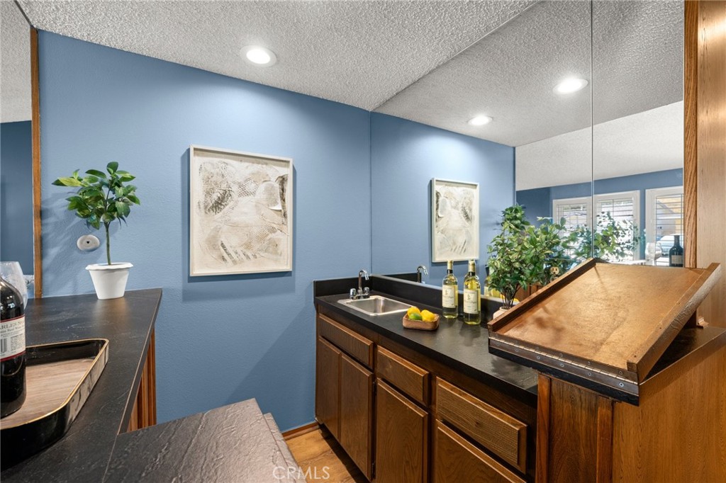 26017 Redbluff Drive Calabasas, CA 91302 - Photo 7 of 29 a room with table flowerpot and wooden floor