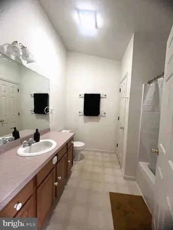 a spacious bathroom with a sink a mirror and a bathtub