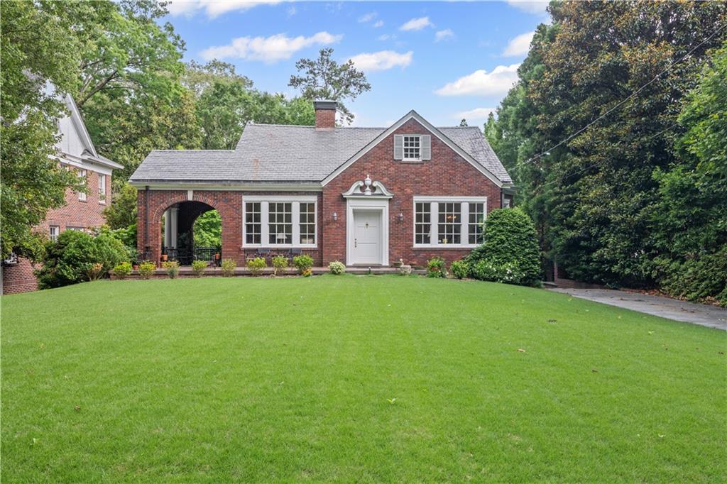a front view of a house with a garden