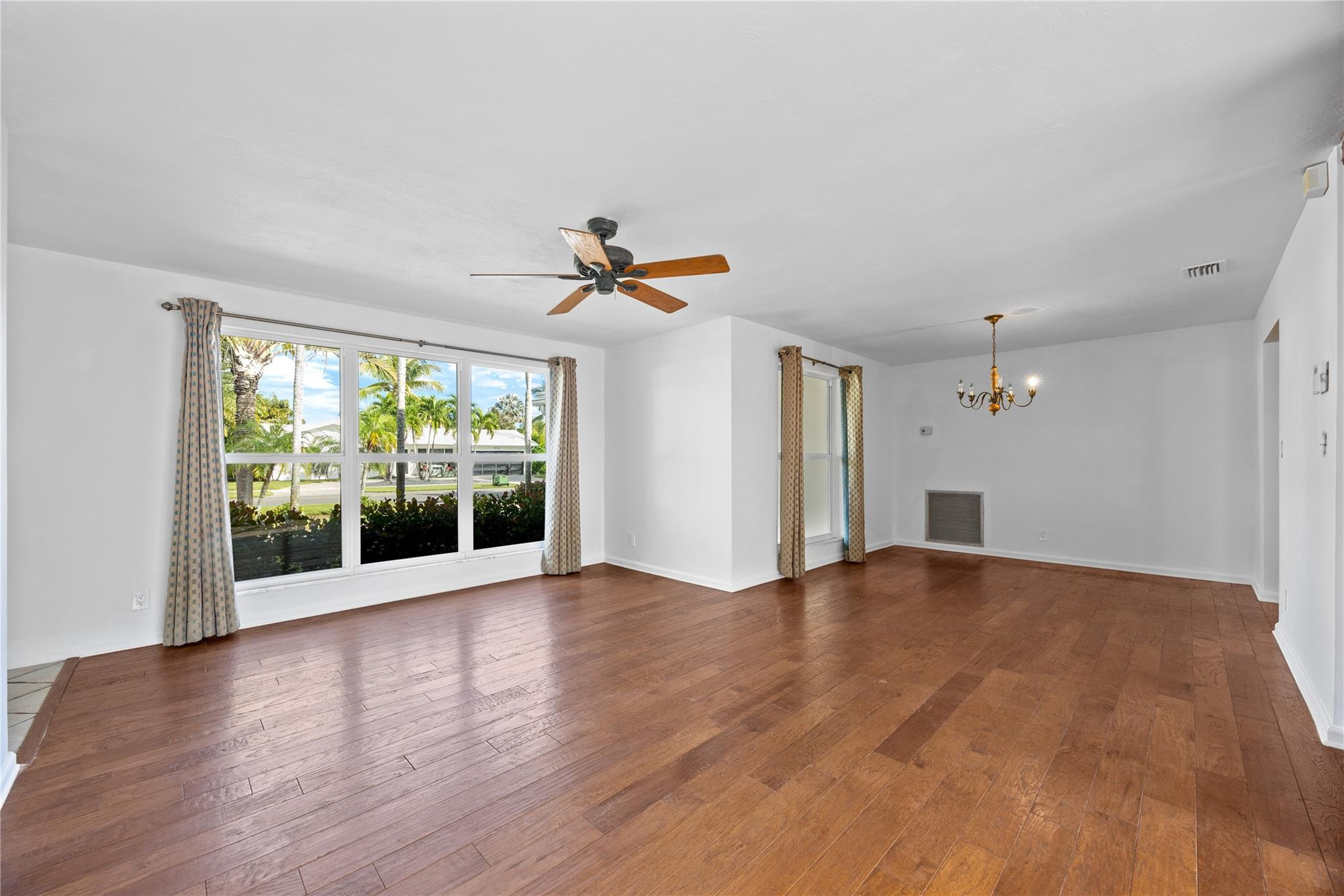 6543 Northeast 21st Road Fort Lauderdale, FL 33308 - Photo 14 of 38 a view of empty room with wooden floor and fan