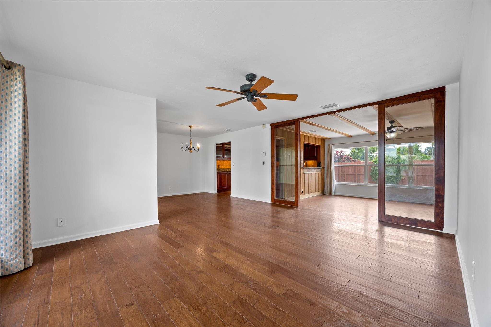 6543 Northeast 21st Road Fort Lauderdale, FL 33308 - Photo 15 of 38 wooden floor in an empty room with a window