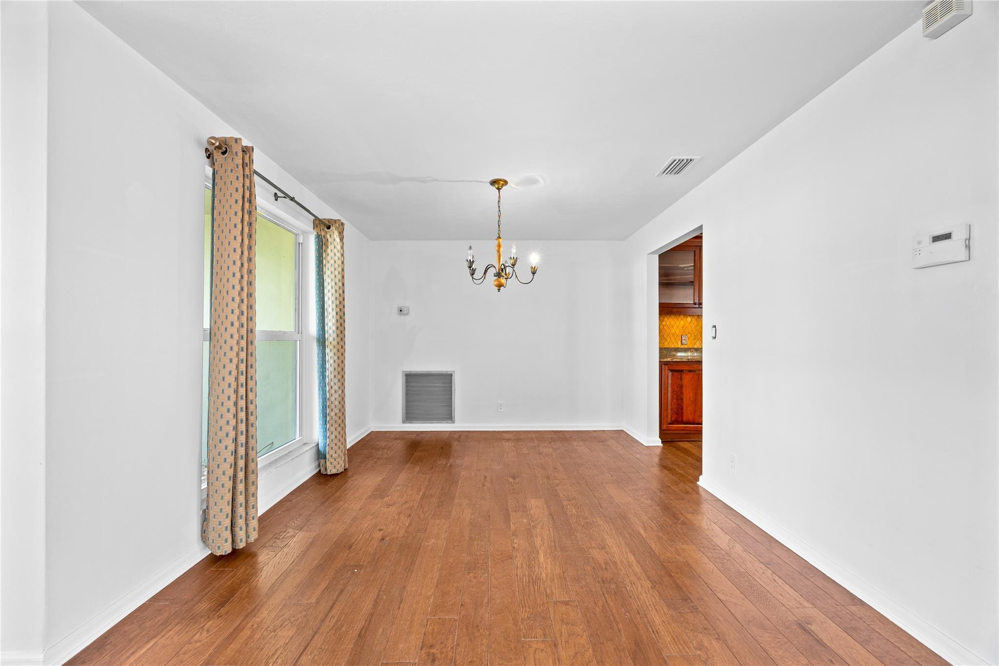 6543 Northeast 21st Road Fort Lauderdale, FL 33308 - Photo 17 of 38 a view of a livingroom with wooden floor and a ceiling fan