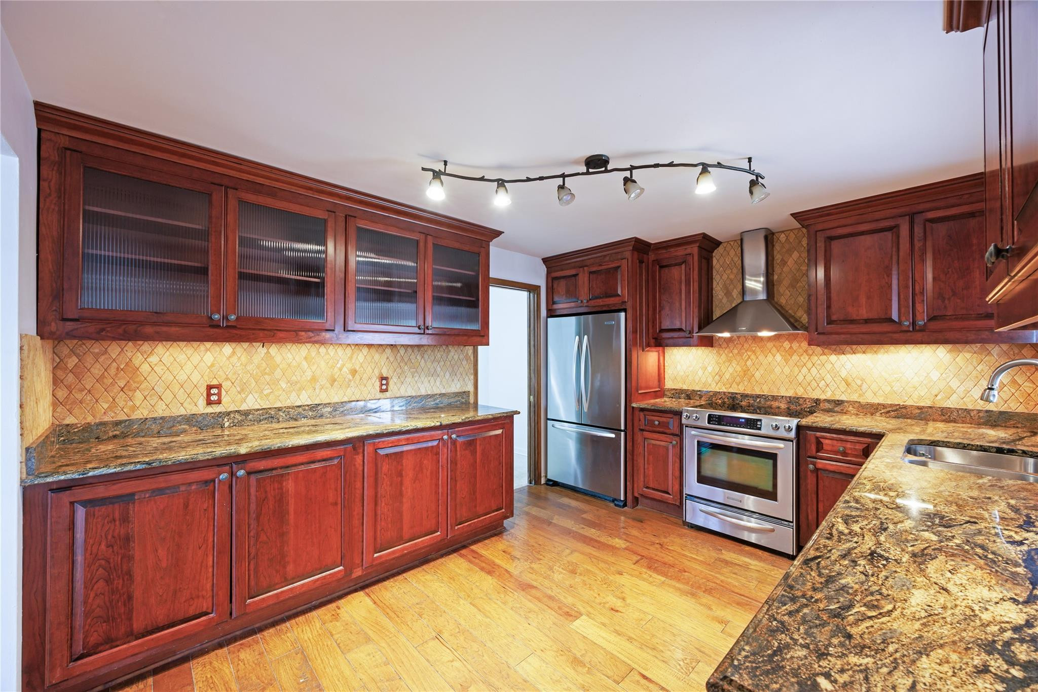 6543 Northeast 21st Road Fort Lauderdale, FL 33308 - Photo 19 of 38 a kitchen with stainless steel appliances granite countertop wooden cabinets a sink and dishwasher