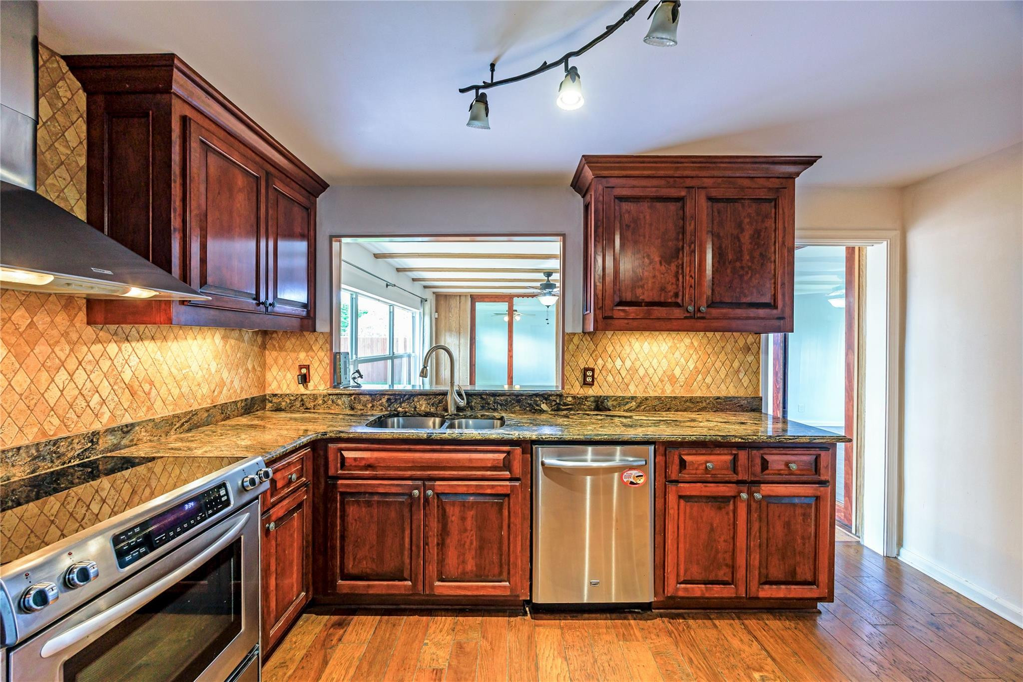 6543 Northeast 21st Road Fort Lauderdale, FL 33308 - Photo 20 of 38 a kitchen with granite countertop wooden cabinets and stainless steel appliances