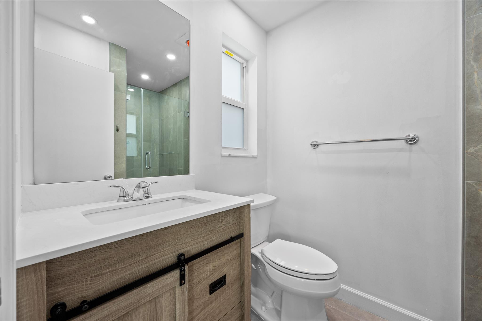 6543 Northeast 21st Road Fort Lauderdale, FL 33308 - Photo 23 of 38 a bathroom with a sink toilet and a mirror