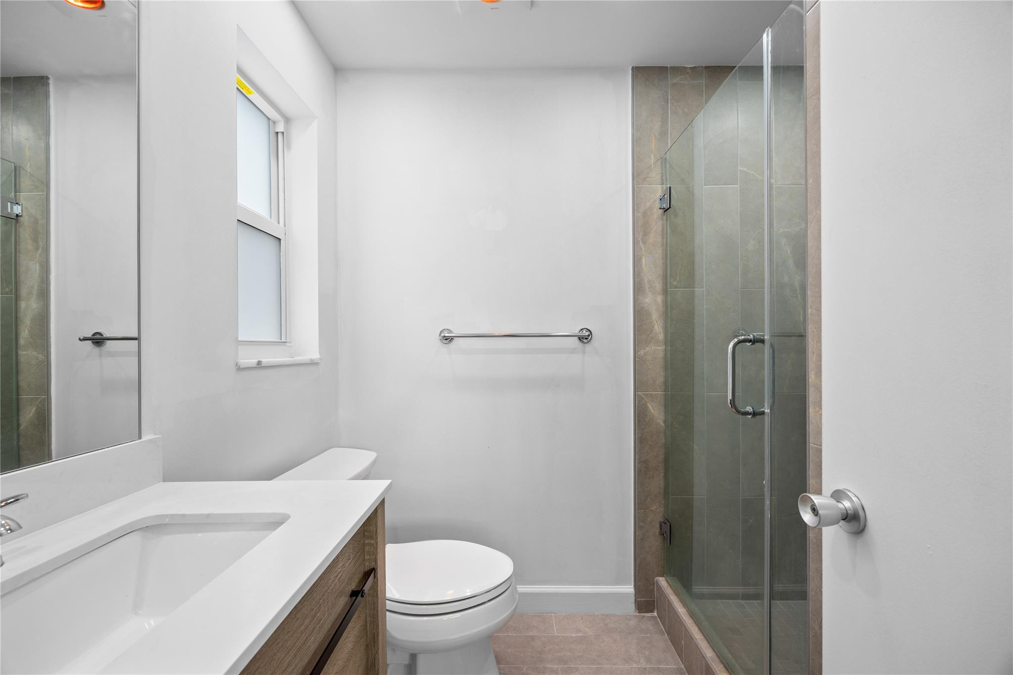 6543 Northeast 21st Road Fort Lauderdale, FL 33308 - Photo 24 of 38 a bathroom with a sink a toilet and shower