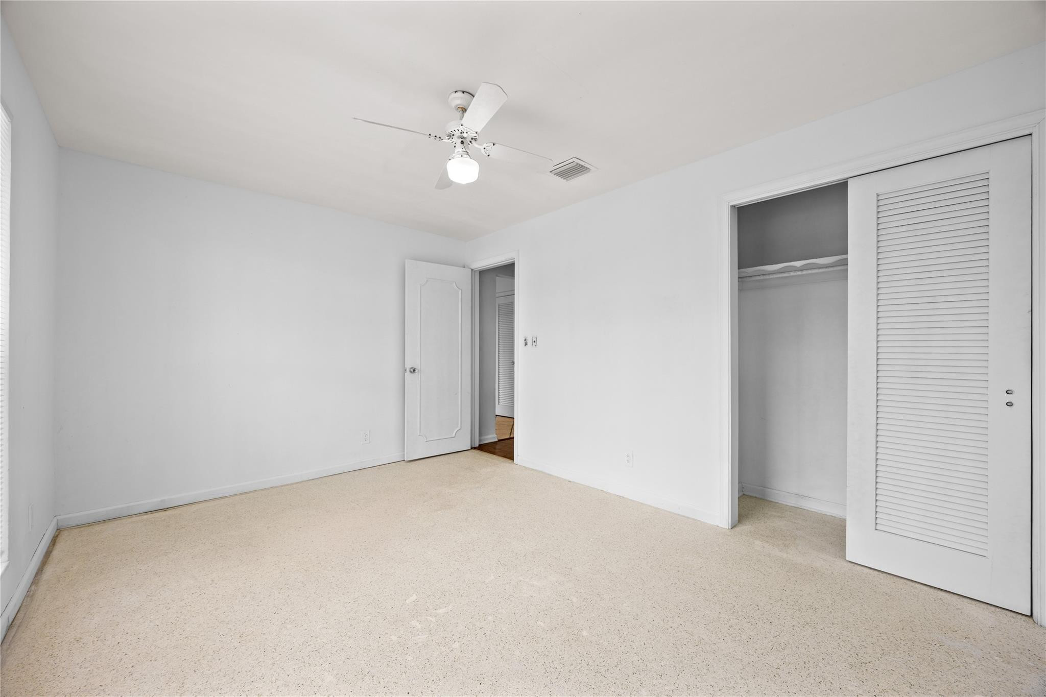 6543 Northeast 21st Road Fort Lauderdale, FL 33308 - Photo 25 of 38 a view of an empty room with a chandelier fan
