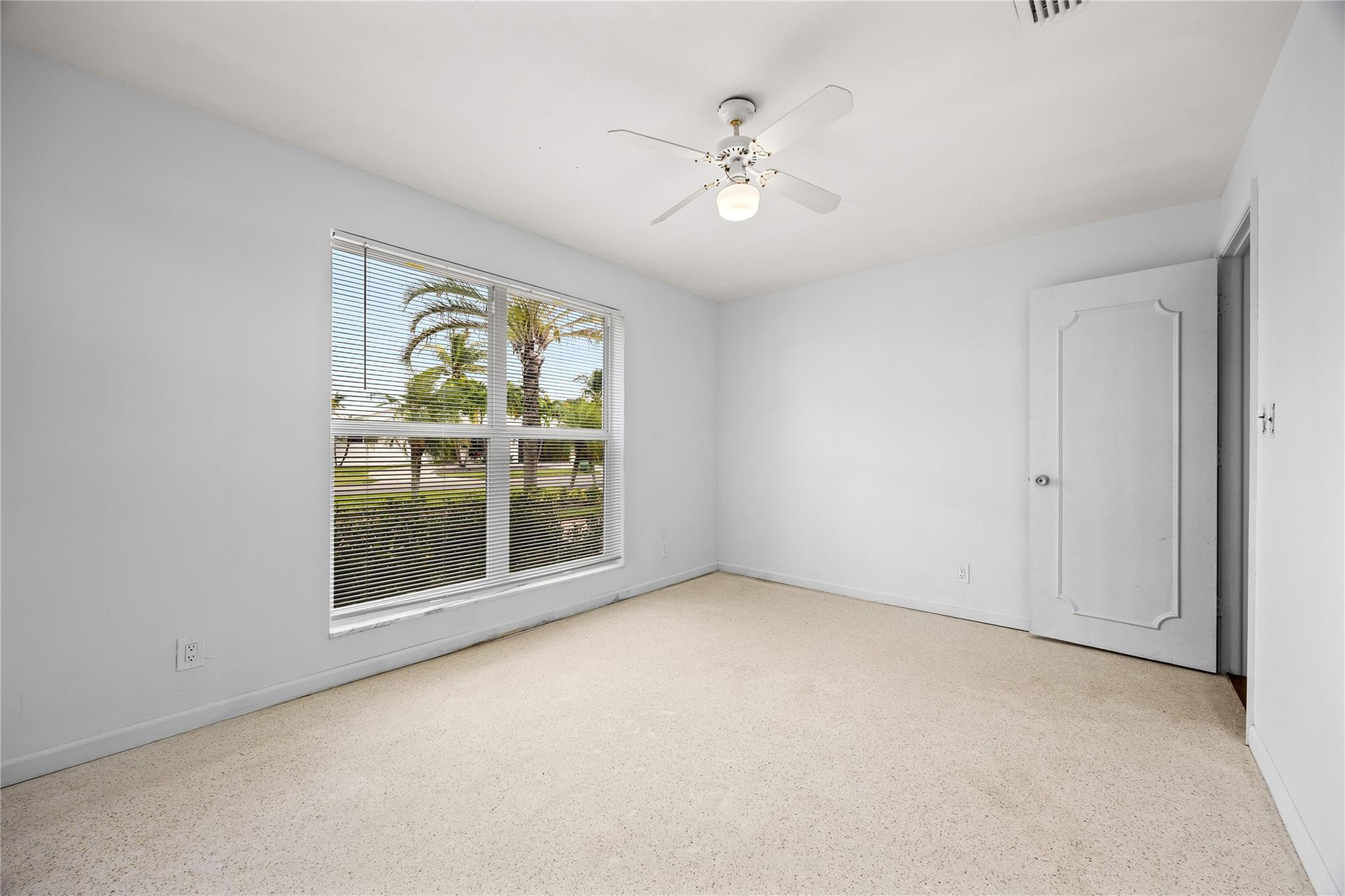 6543 Northeast 21st Road Fort Lauderdale, FL 33308 - Photo 26 of 38 an empty room with windows and fan