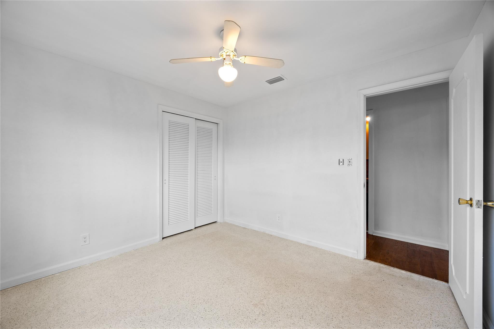 6543 Northeast 21st Road Fort Lauderdale, FL 33308 - Photo 28 of 38 an empty room with a chandelier fan