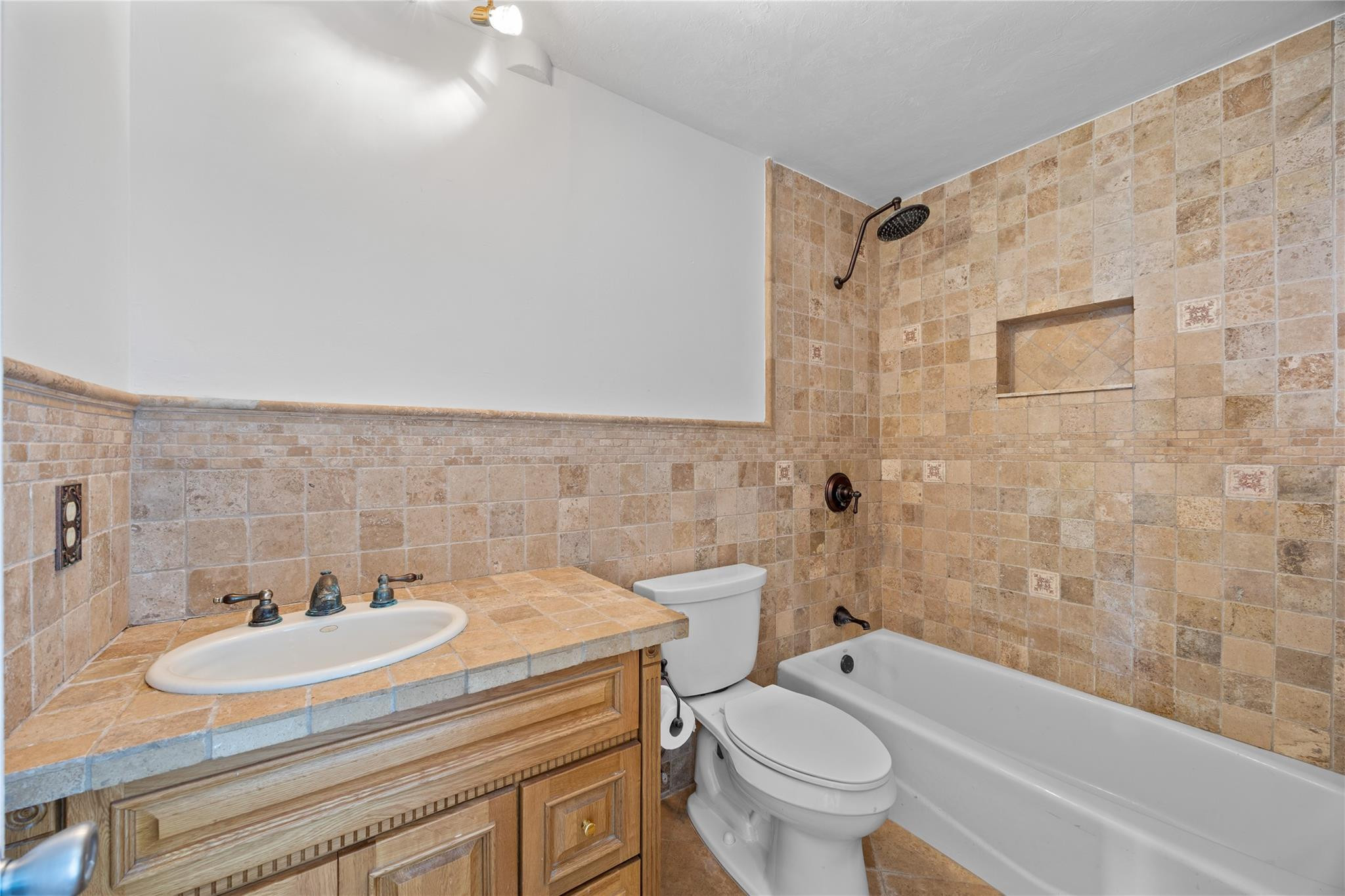 6543 Northeast 21st Road Fort Lauderdale, FL 33308 - Photo 32 of 38 a bathroom with a sink a toilet and a bathtub