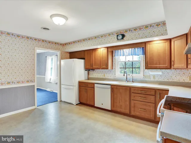 a kitchen with sink and cabinets