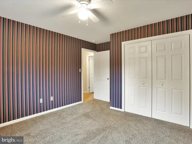 a view of an empty room with wooden walls